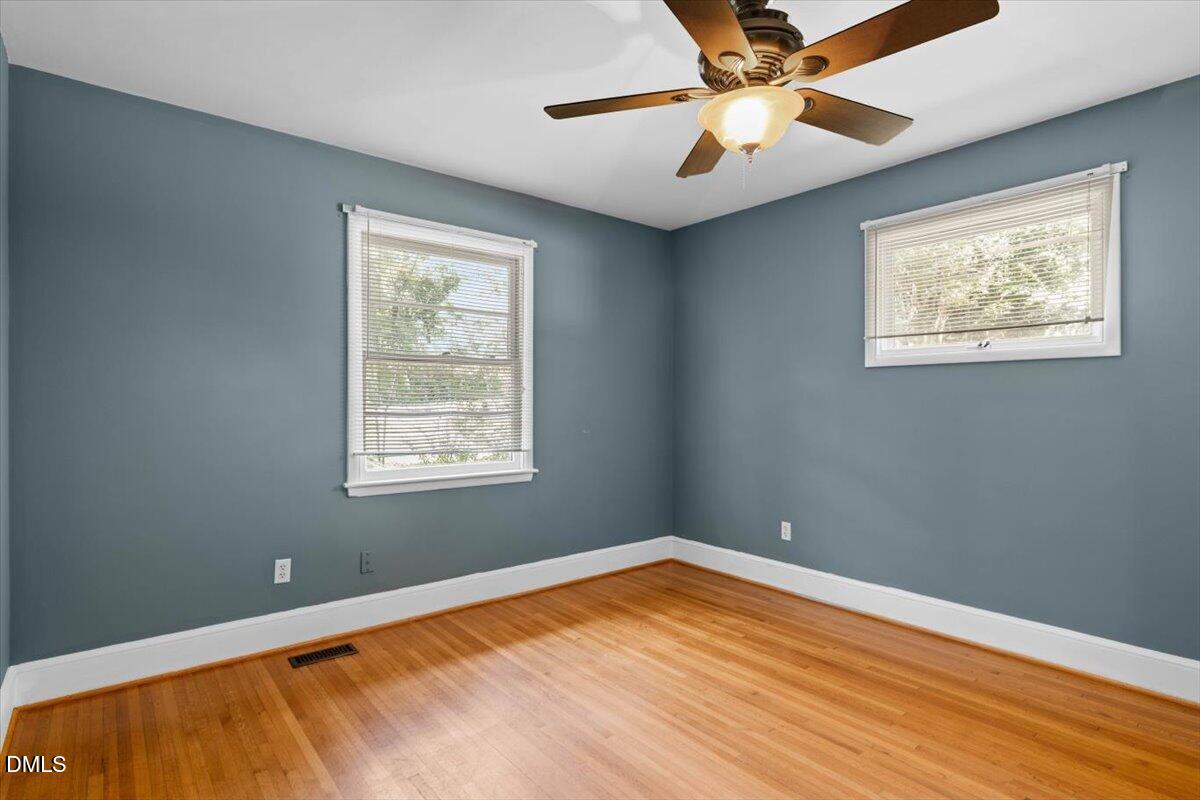 1401 Spring Forest Road Raleigh, NC 27615 - Photo 28 of 47 a view of an empty room with window and a chandelier fan