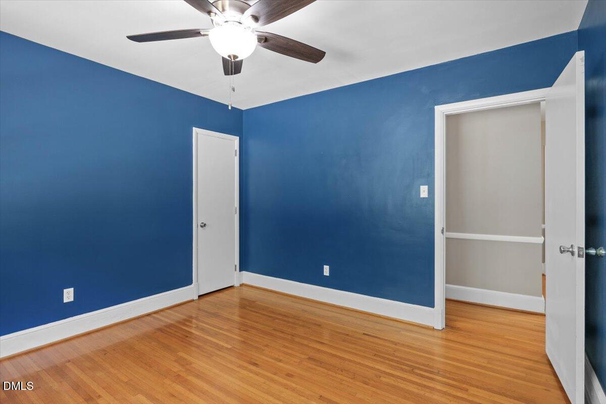 1401 Spring Forest Road Raleigh, NC 27615 - Photo 32 of 47 a view of an empty room with wooden floor