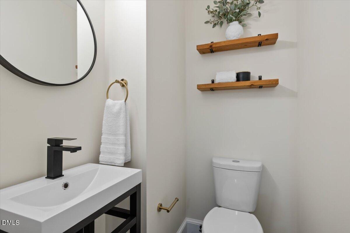 1401 Spring Forest Road Raleigh, NC 27615 - Photo 34 of 47 a bathroom with a toilet and a sink