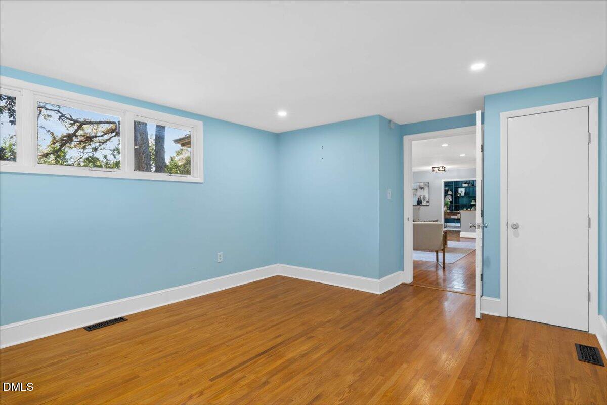 1401 Spring Forest Road Raleigh, NC 27615 - Photo 36 of 47 a view of empty room with wooden floor
