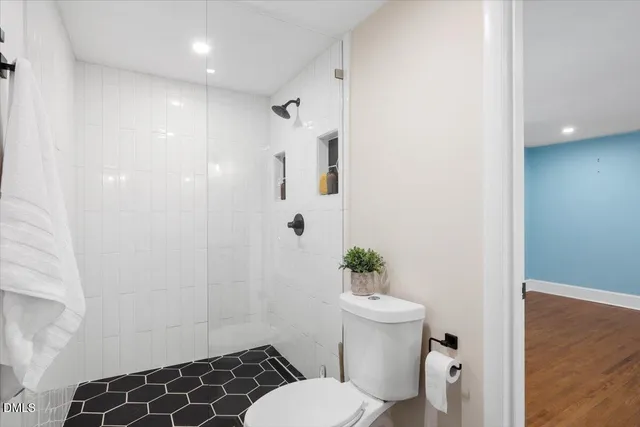 a bathroom with a toilet and a shower