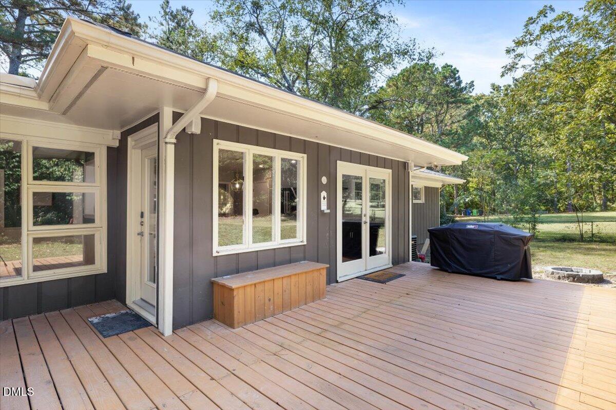 1401 Spring Forest Road Raleigh, NC 27615 - Photo 38 of 47 a view of house with deck outdoor seating and wooden floor