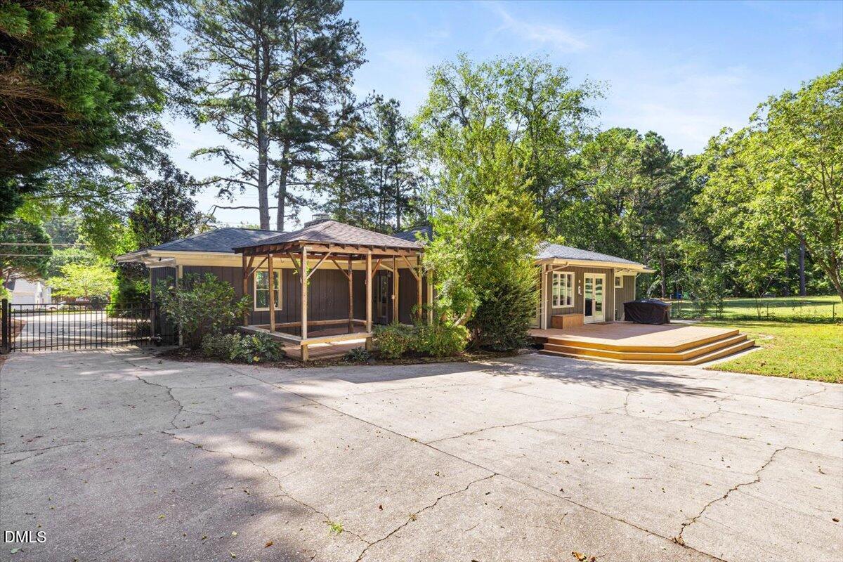 1401 Spring Forest Road Raleigh, NC 27615 - Photo 44 of 47 a view of a house with a swimming pool and sitting area