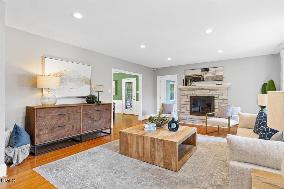 1401 Spring Forest Road Raleigh, NC 27615 - Photo 7 of 47 a living room with furniture a fireplace and a large window