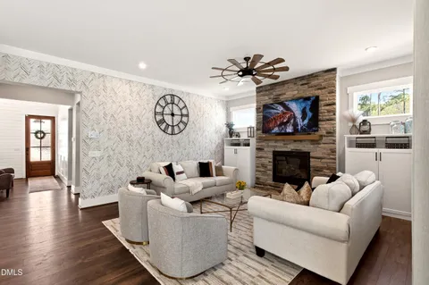 a living room with furniture a fireplace and a flat screen tv