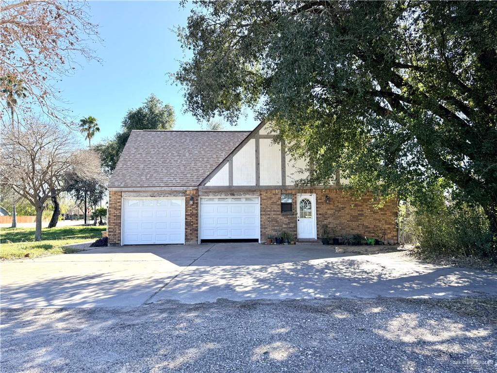 603 South Alamo Road Alamo, TX 78516 - Photo 2 of 17 a view of a house with a yard and garage
