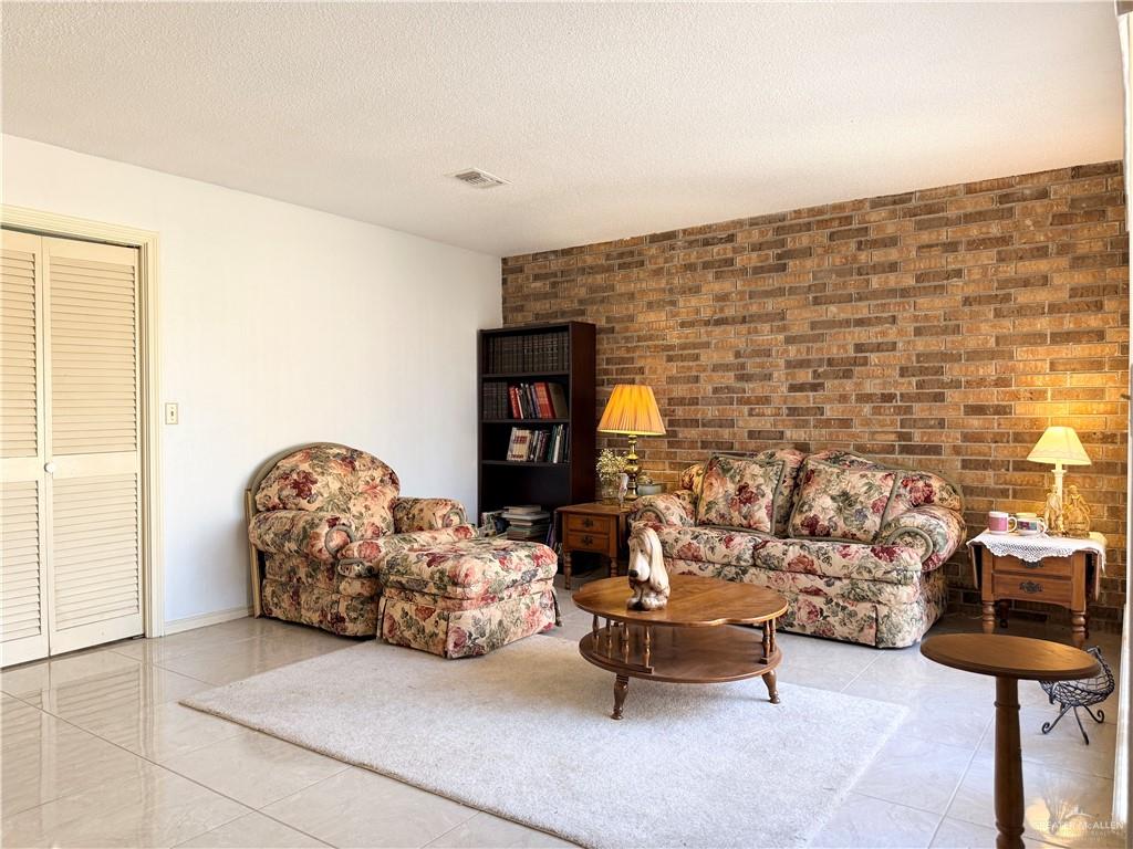 603 South Alamo Road Alamo, TX 78516 - Photo 3 of 17 a bedroom with furniture and a lamp