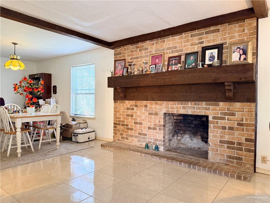 603 South Alamo Road Alamo, TX 78516 - Photo 4 of 17 a living room with furniture a fireplace and a table