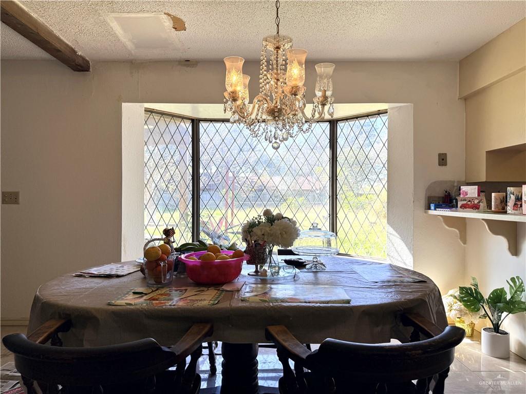 603 South Alamo Road Alamo, TX 78516 - Photo 6 of 17 a view of a dining room with furniture and window
