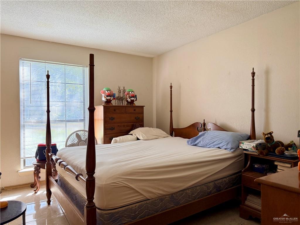 603 South Alamo Road Alamo, TX 78516 - Photo 8 of 17 a bedroom with a bed and a dresser