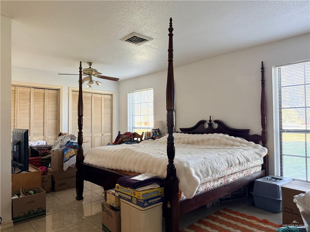 603 South Alamo Road Alamo, TX 78516 - Photo 10 of 17 a bedroom with a bed and large windows