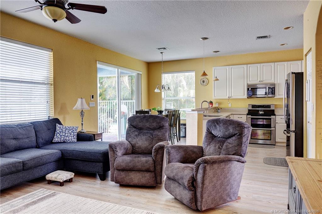 2120 Northwest Marsh Rabbit Lane Jensen Beach, FL 34957 - Photo 26 of 34 a living room with furniture and a large window