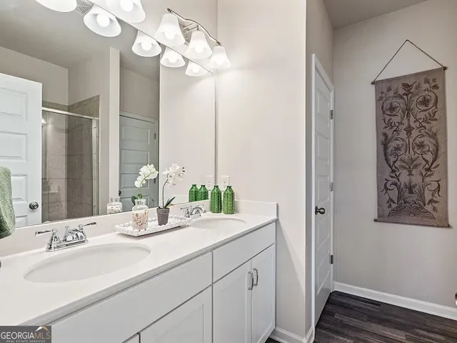 a bathroom with a sink a mirror and a light fixture