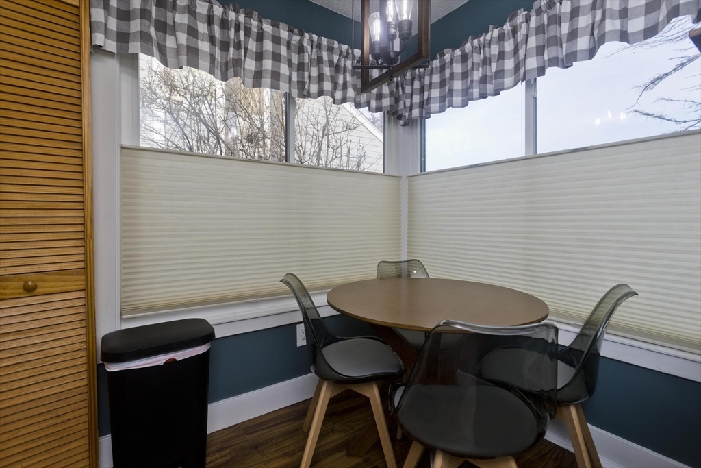 433 Nassau Drive, Unit 433 Springfield, MA 01129 - Photo 13 of 41 a view of a dining room with furniture and wooden floor