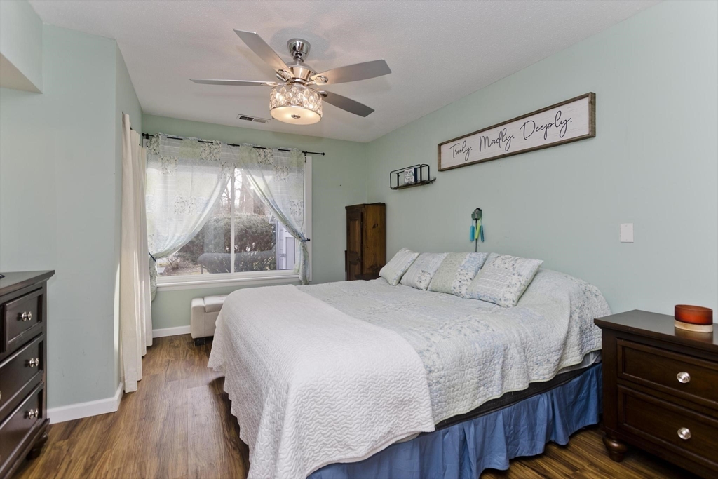 433 Nassau Drive, Unit 433 Springfield, MA 01129 - Photo 26 of 41 a bedroom with a large bed and a chandelier