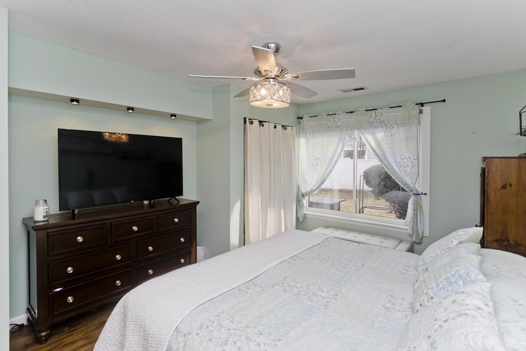 433 Nassau Drive, Unit 433 Springfield, MA 01129 - Photo 27 of 41 a bedroom with a bed and a flat screen tv