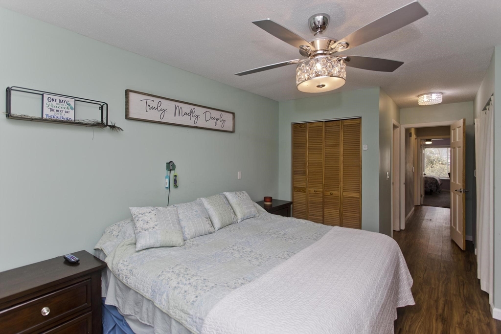 433 Nassau Drive, Unit 433 Springfield, MA 01129 - Photo 28 of 41 a bedroom with a bed and a chandelier