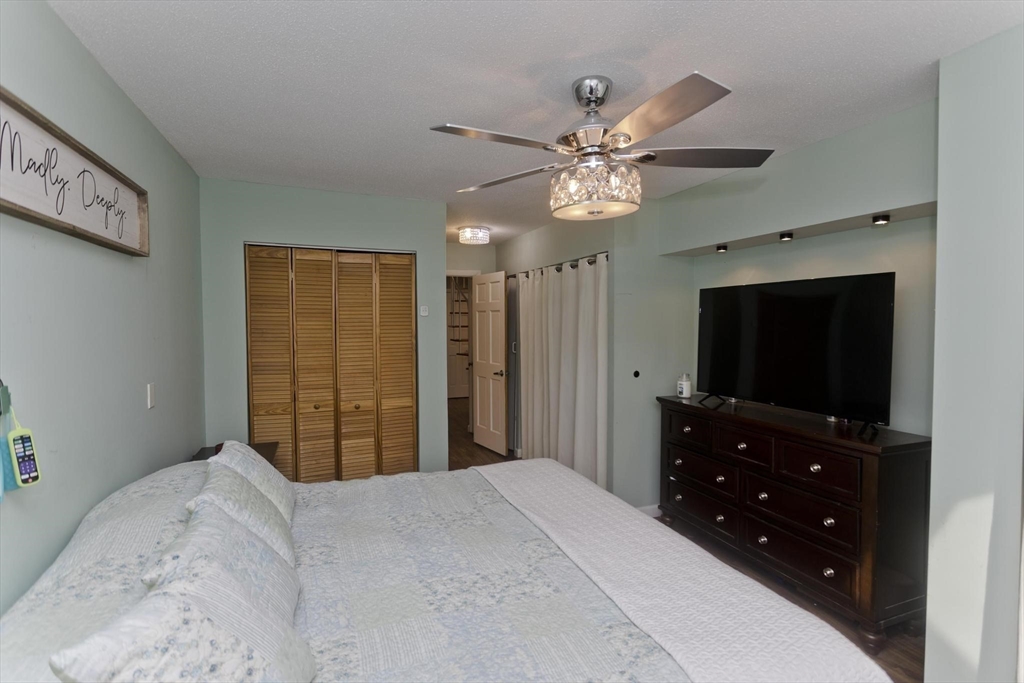 433 Nassau Drive, Unit 433 Springfield, MA 01129 - Photo 29 of 41 a bedroom with a bed and a flat screen tv