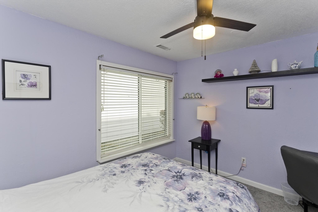 433 Nassau Drive, Unit 433 Springfield, MA 01129 - Photo 34 of 41 a bedroom with a bed and a chandelier
