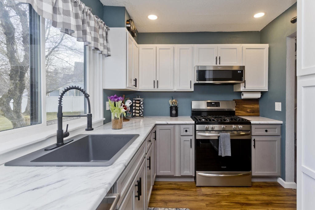 433 Nassau Drive, Unit 433 Springfield, MA 01129 - Photo 6 of 41 a kitchen with stainless steel appliances granite countertop a sink stove and refrigerator