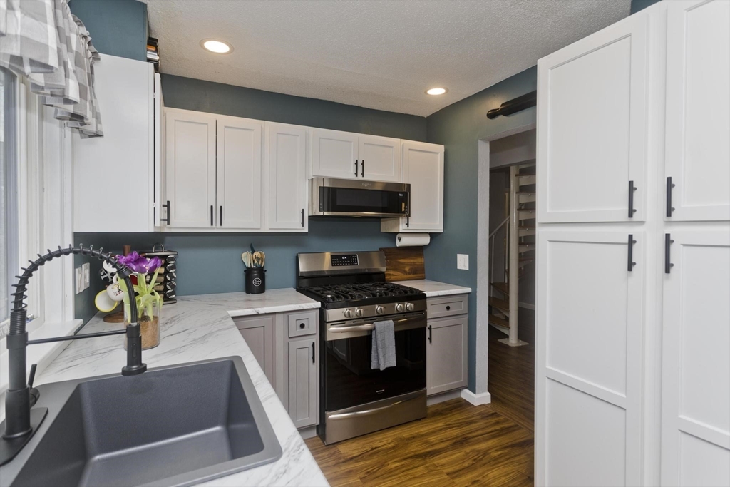 433 Nassau Drive, Unit 433 Springfield, MA 01129 - Photo 8 of 41 a kitchen with stainless steel appliances granite countertop a stove a sink and a refrigerator