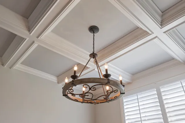 a kitchen with stainless steel appliances granite countertop a sink a stove a refrigerator and island with wooden floor