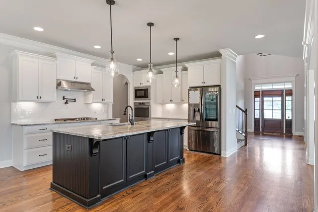 a kitchen with a sink stove and refrigerator