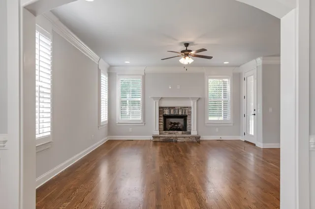 a kitchen with stainless steel appliances granite countertop a sink a stove and a wooden floors