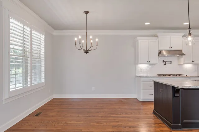 a view of a room window and wooden floor