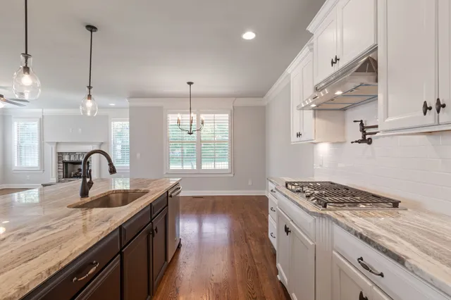 a bathroom with a double vanity sink a large mirror and shower