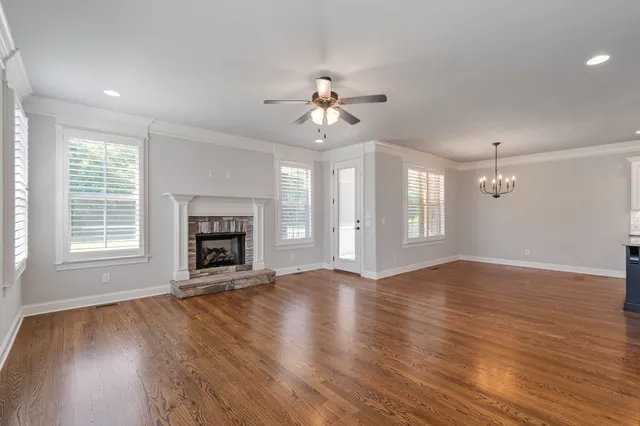 a kitchen with stainless steel appliances and wooden floor