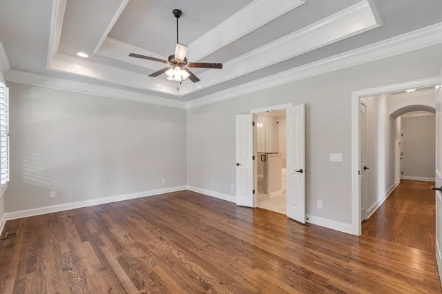 a view of an empty room with a ceiling fan