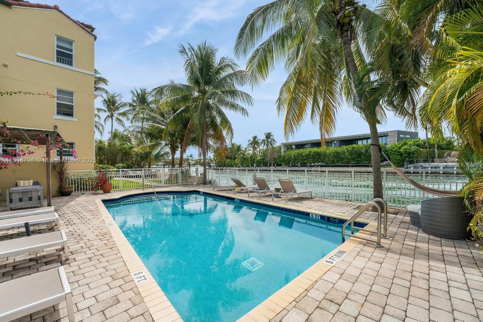 4812 Pine Tree Drive, Unit 206 Miami Beach, FL 33140 - Photo 12 of 14 a view of a swimming pool with a patio
