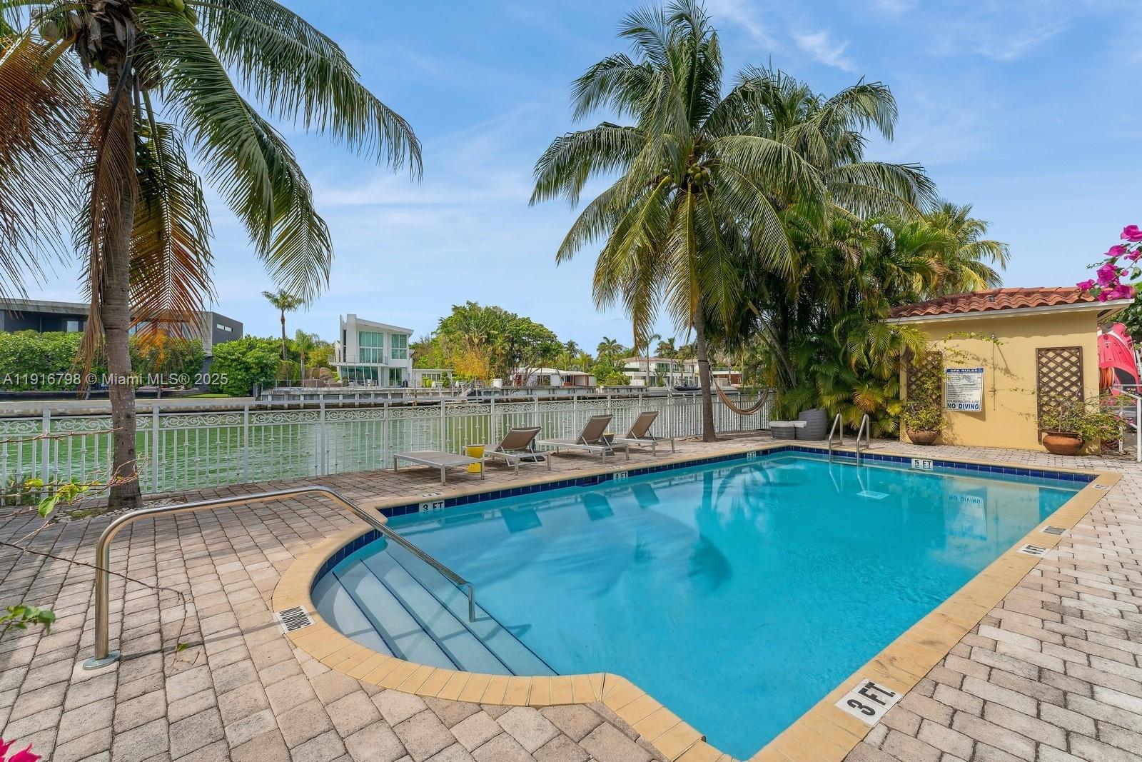4812 Pine Tree Drive, Unit 206 Miami Beach, FL 33140 - Photo 13 of 14 a swimming pool with outdoor seating and yard