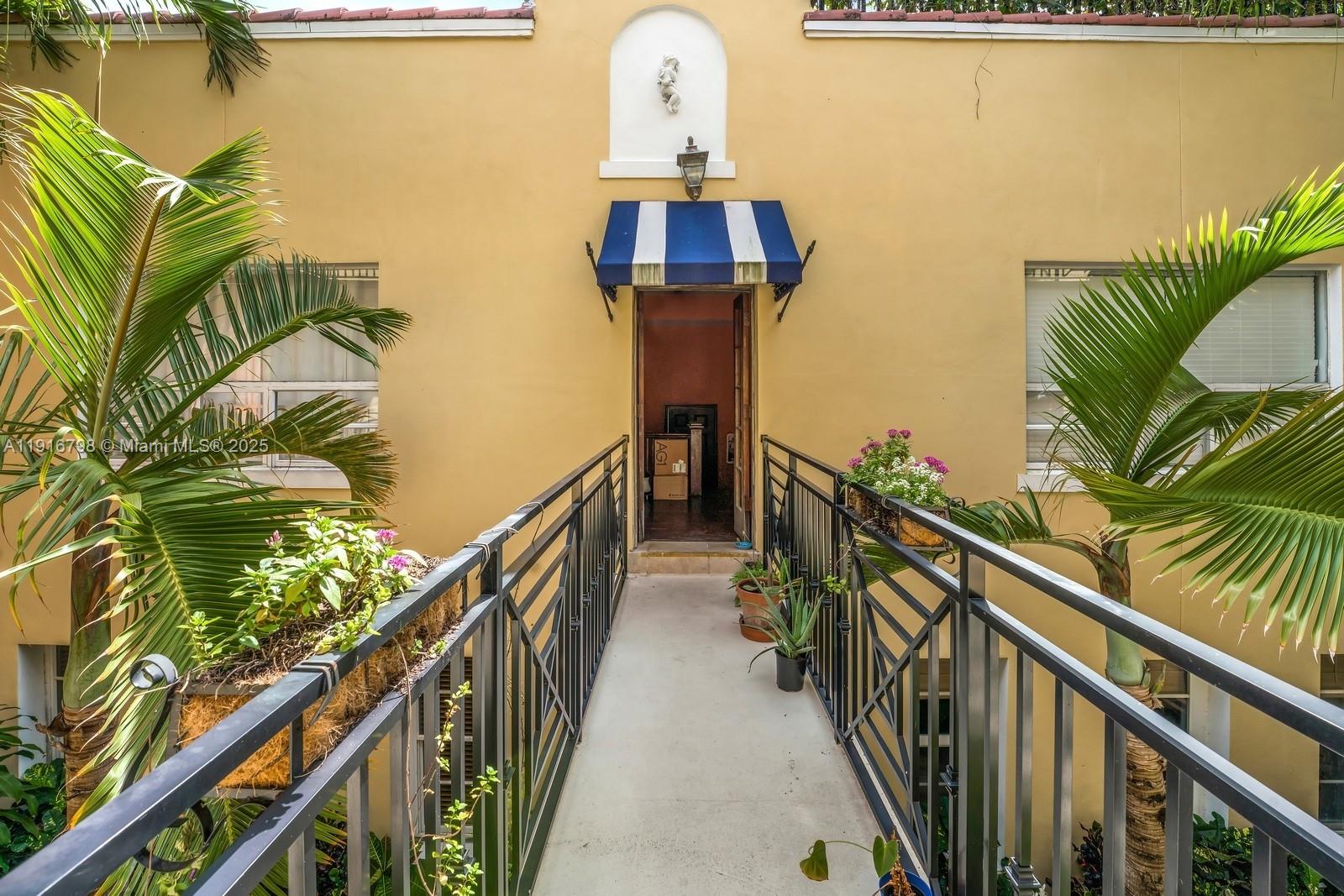 4812 Pine Tree Drive, Unit 206 Miami Beach, FL 33140 - Photo 2 of 14 a view of a balcony with wooden floor and stairs