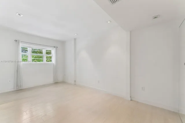 a view of an empty room with a glass door