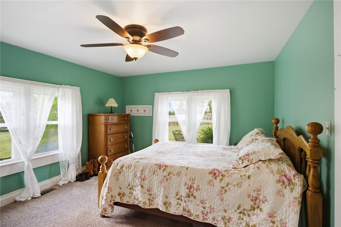 199 Williams Farm Road Westminster, SC 29693 - Photo 12 of 47 This cozy bedroom features bright windows, soft carpeting, and a classic ceiling fan for ultimate comfort.