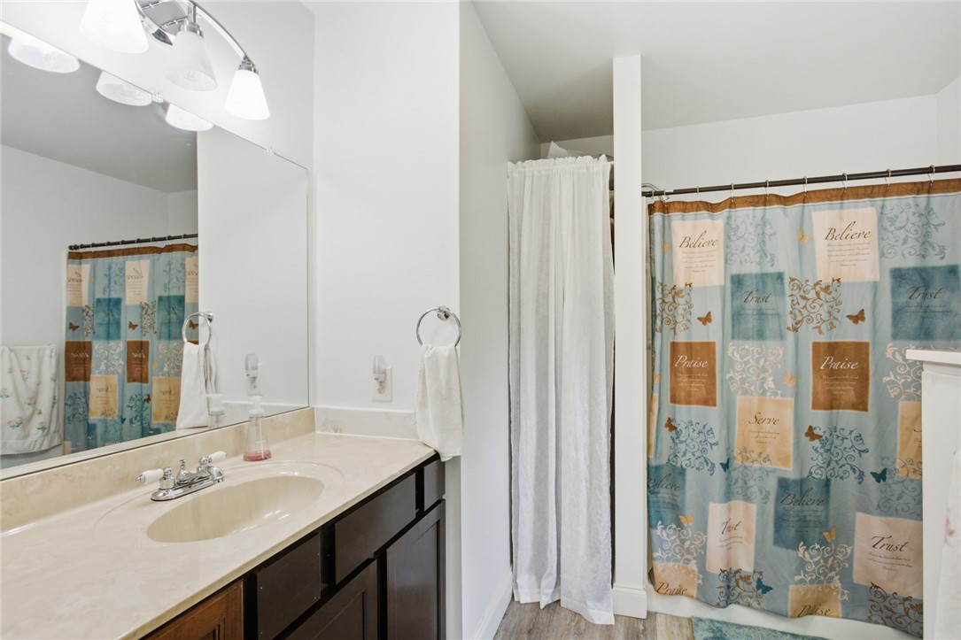 199 Williams Farm Road Westminster, SC 29693 - Photo 14 of 47 This bright bathroom features a spacious vanity, large mirror, and practical shower area.