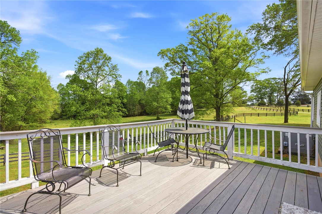 199 Williams Farm Road Westminster, SC 29693 - Photo 23 of 47 Enjoy tranquil views of lush greenery from this inviting outdoor deck, perfect for relaxation.