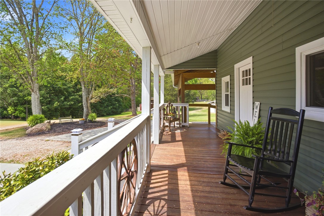 199 Williams Farm Road Westminster, SC 29693 - Photo 25 of 47 Relax on this charming covered porch, offering tranquil views of the verdant surroundings.