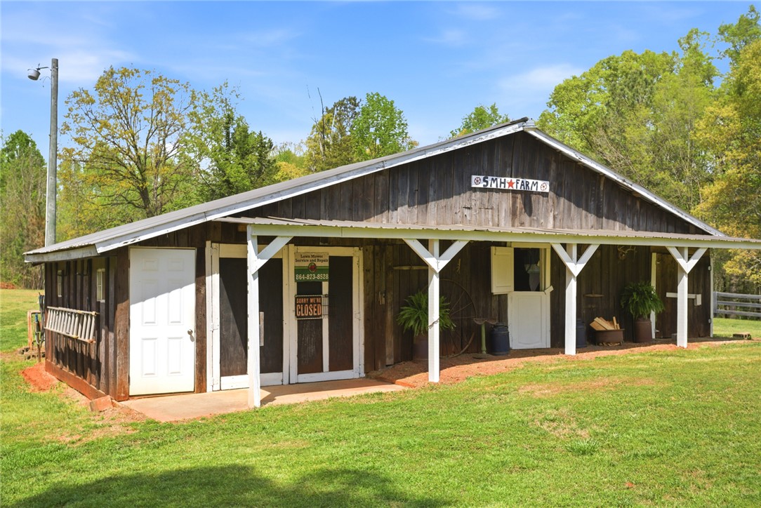 199 Williams Farm Road Westminster, SC 29693 - Photo 27 of 47 This rustic barn offers versatile functionality amidst a serene, natural backdrop.