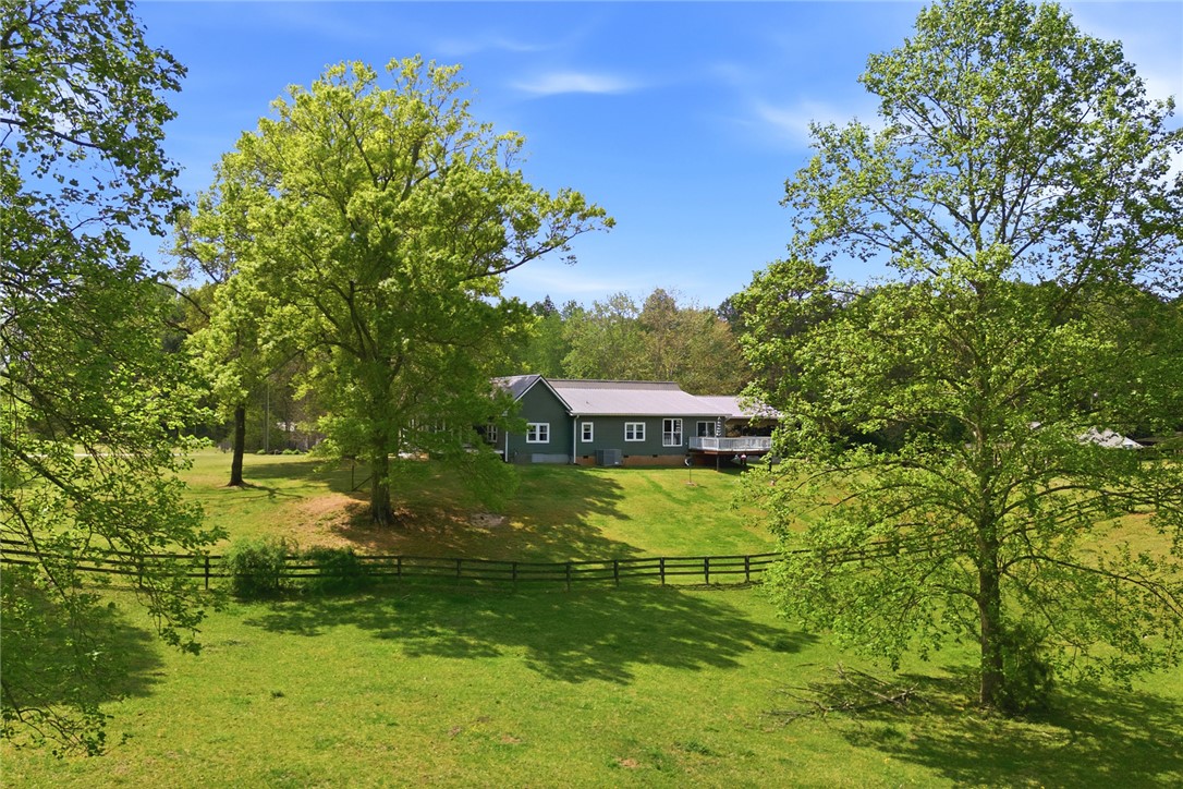 199 Williams Farm Road Westminster, SC 29693 - Photo 43 of 47 This tranquil property boasts a charming residence nestled amidst expansive green lawns and mature trees.