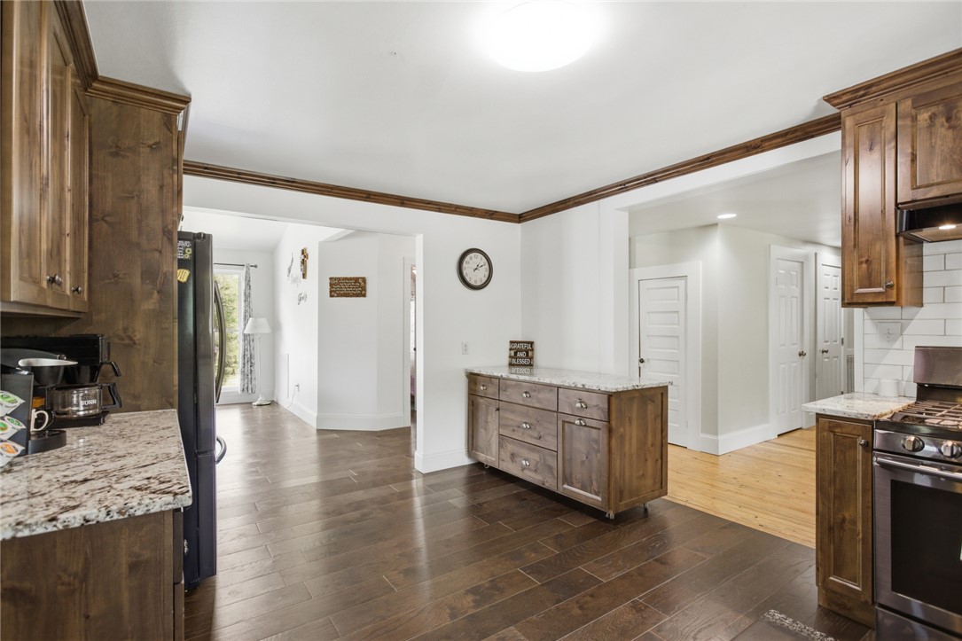 199 Williams Farm Road Westminster, SC 29693 - Photo 6 of 47 This spacious kitchen features richly stained cabinetry, granite countertops, and modern appliances, perfect for everyday living.