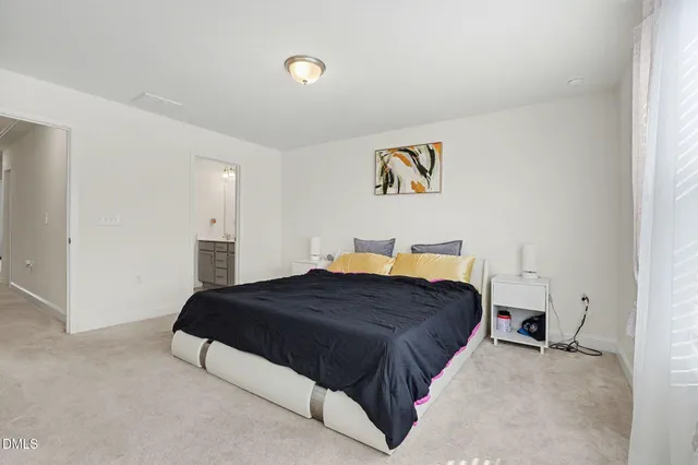 a bedroom with a bed and a wall painting