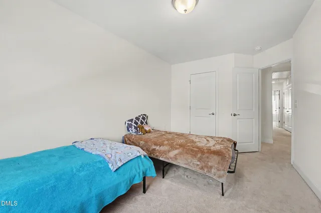 a bedroom with two beds and painted walls