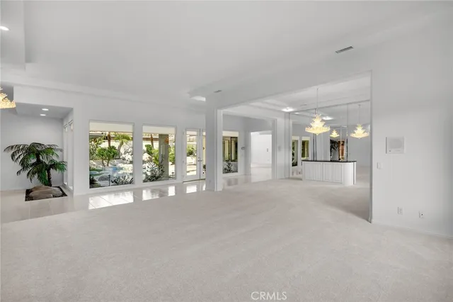a view of a hallway with wooden floor and a large window