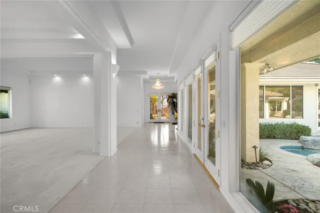 a view of a hallway view with large mirror and window