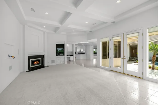 a view of a big room with chandelier and fireplace