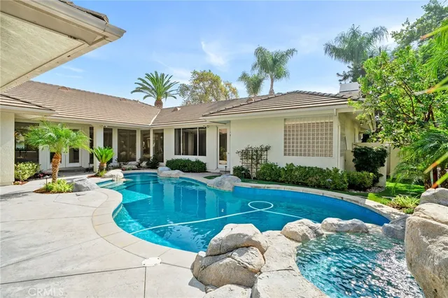 a view of a house with a yard patio and swimming pool
