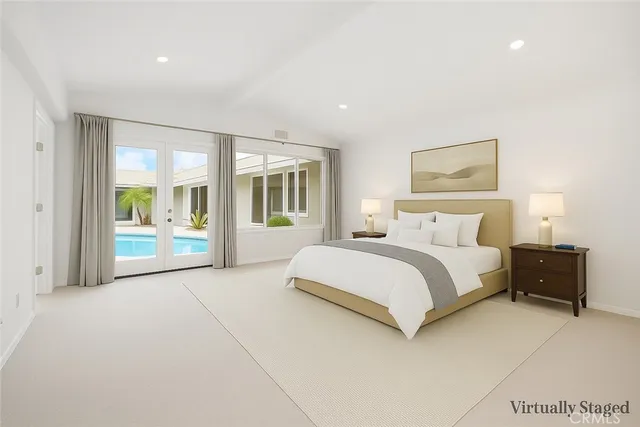 a spacious bedroom with a large bed and a large window